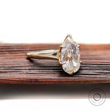 Minimal prong set pear moissanite ring high polish finish