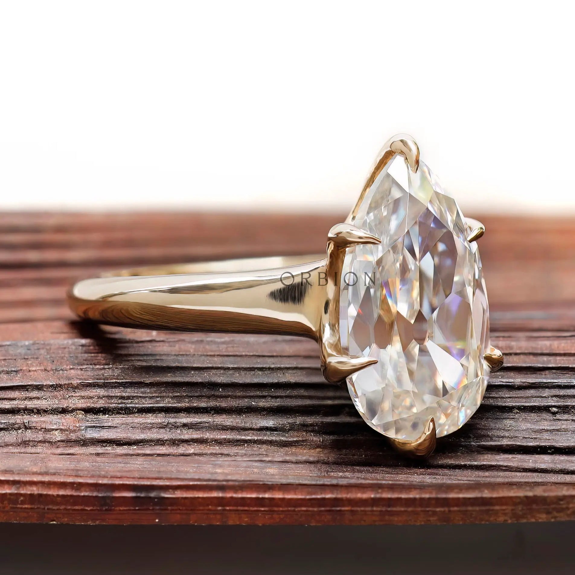 Minimal prong set pear moissanite ring high polish finish