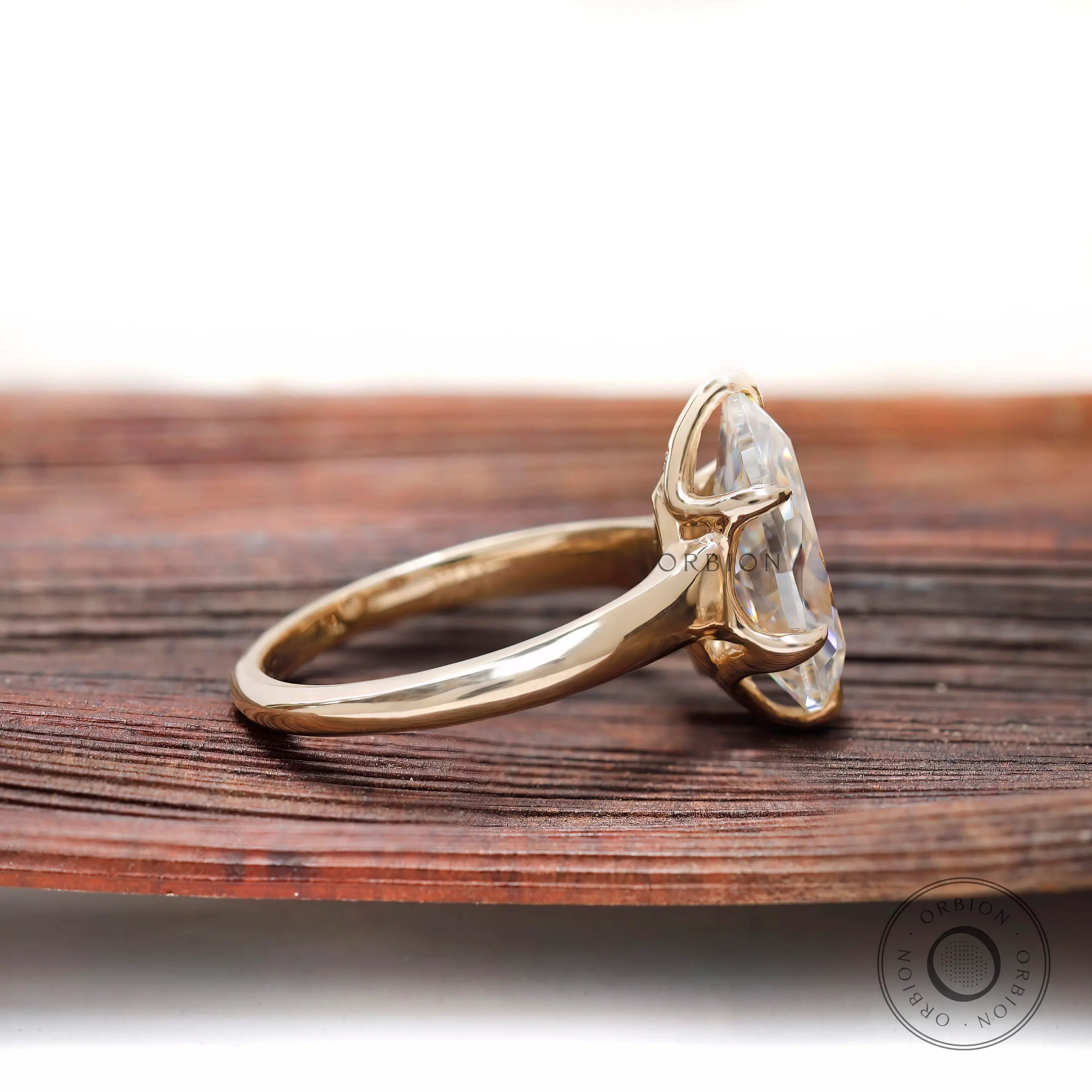 Side profile pear moissanite ring with prong setting
