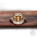 Front view of cushion-shaped Dark Champagne ring with bezel in yellow gold.