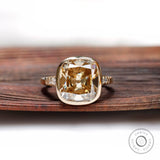 Front view of cushion-shaped Dark Champagne ring with bezel in yellow gold.