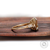 Side profile view of chunky elongated cushion ring in yellow gold.