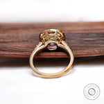 Back view of elongated cushion Moissanite ring with side set in yellow gold.