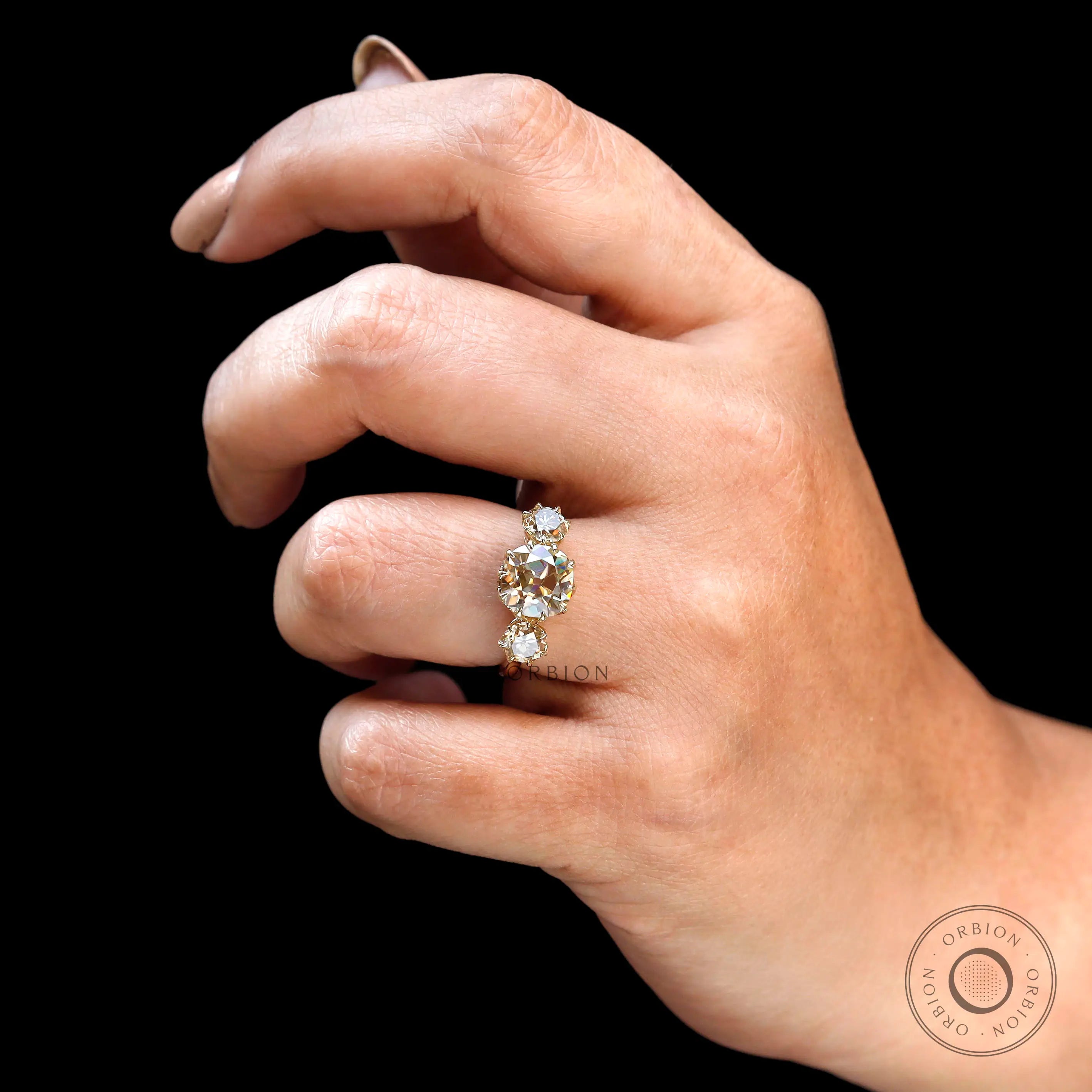 Vintage inspired three stone engagement ring in warm tones
