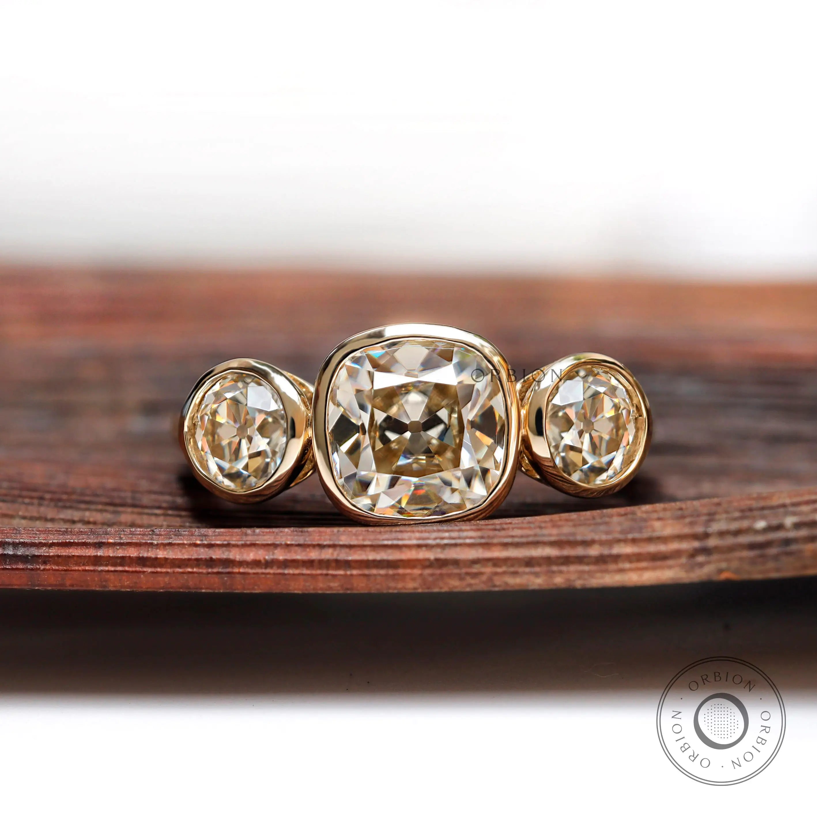 Three stone cushion moissanite ring in 10K yellow gold front view