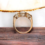 Gallery detail of three stone yellow gold setting