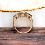 Gallery detail of three stone yellow gold setting