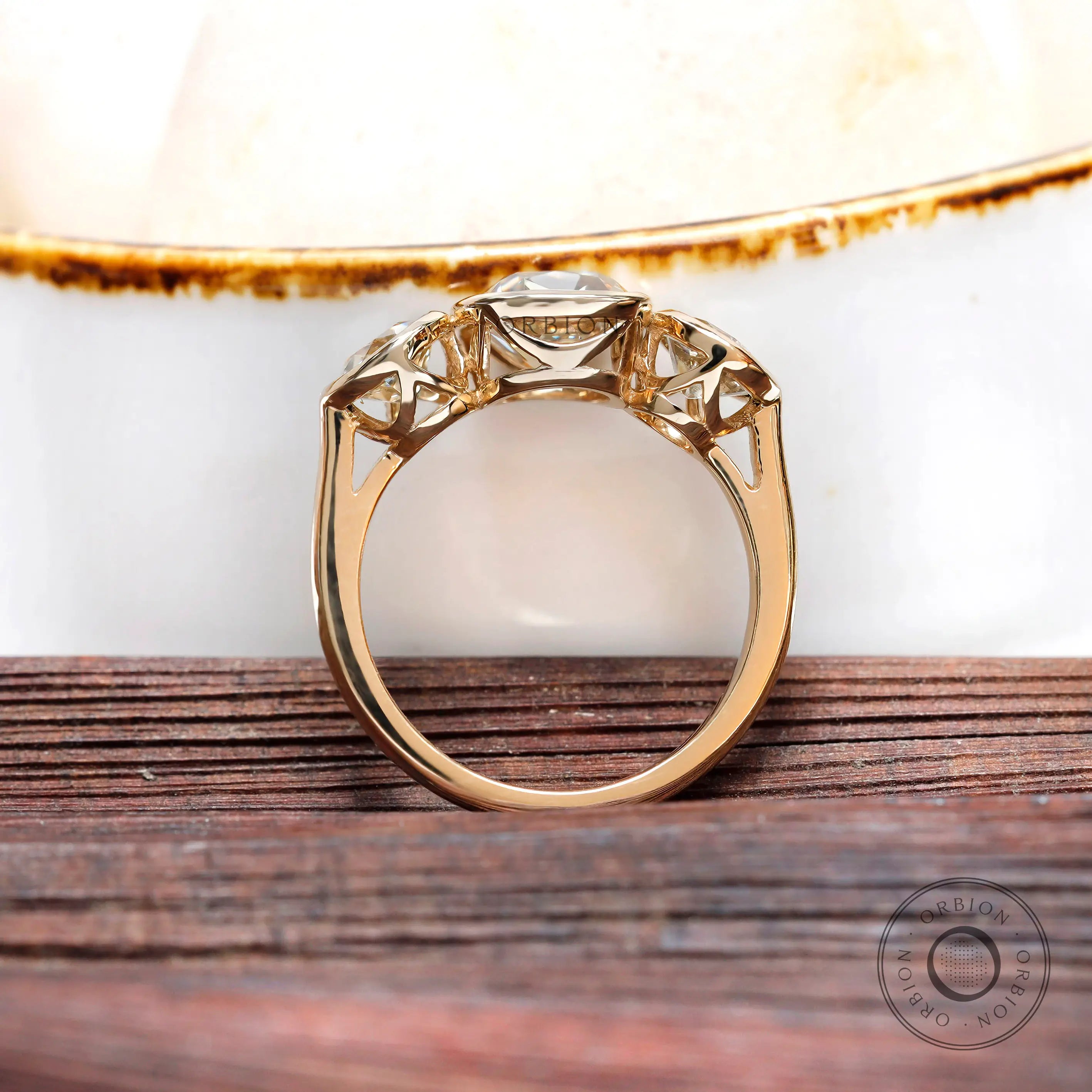 Gallery detail of three stone yellow gold setting