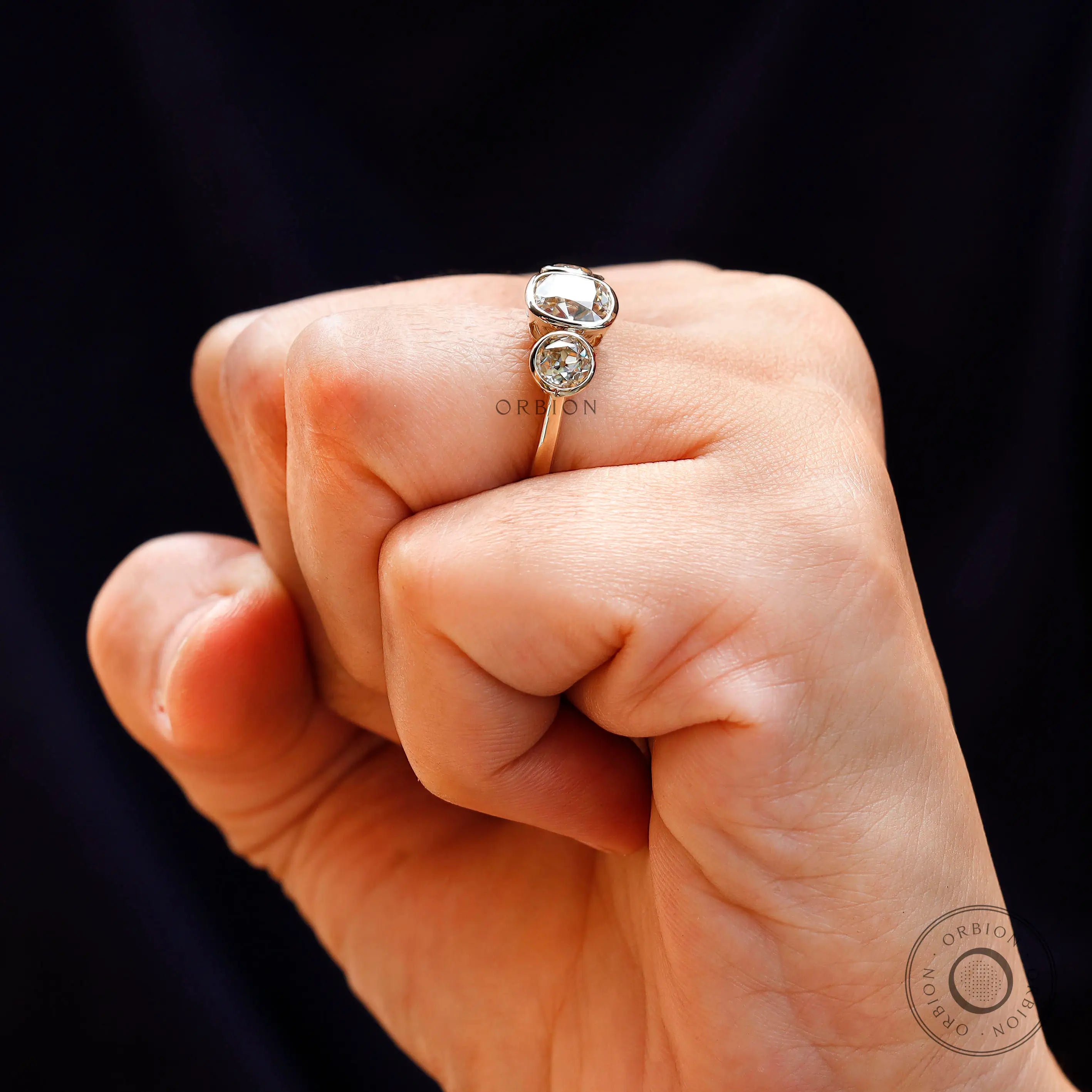 Side profile of three stone champagne moissanite ring