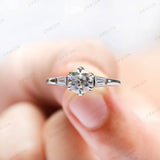 Minimal trilogy vintage engagement ring with step cut side stones  