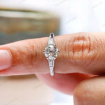 Moissanite three stone engagement ring with baguette accents  