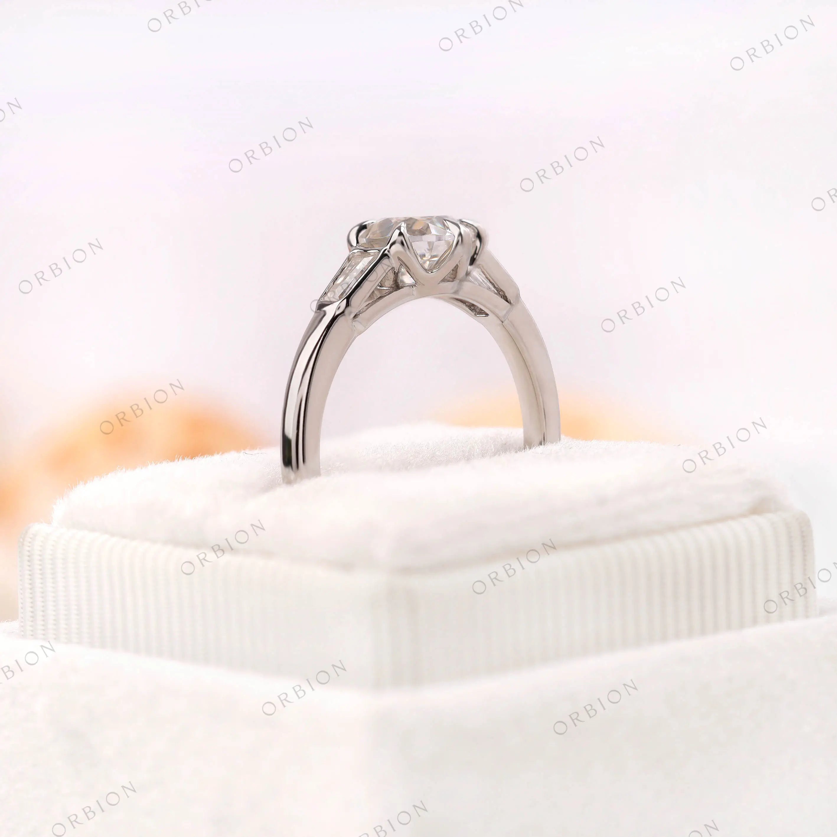 Glossy 10k white gold solitaire ring with tapered baguettes 
