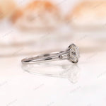 Side profile of three stone engagement ring in white gold 