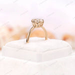 Ring placed on a velvet ring box showing the 1.50 CT round moissanite in 10K yellow gold.
