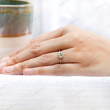 Hand model showcasing the solitaire 10K yellow gold moissanite engagement ring with Old European cut center stone.