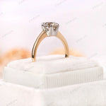 Old European Cut Round Moissanite solitaire ring displayed on a velvet cushion, showing off the stone’s brilliance and the 10K yellow-white gold setting.
