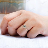 Close-up shot of the ring on a finger, showcasing the elegant bezel setting and the dual-tone 10K gold band.
