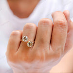 Hand shot of toi et moi moissanite ring worn on finger