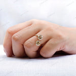 Open style engagement ring with round moissanite stones