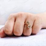 Polished yellow gold open ring with dual moissanite stones