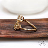 Side profile of toi et moi moissanite ring in yellow gold