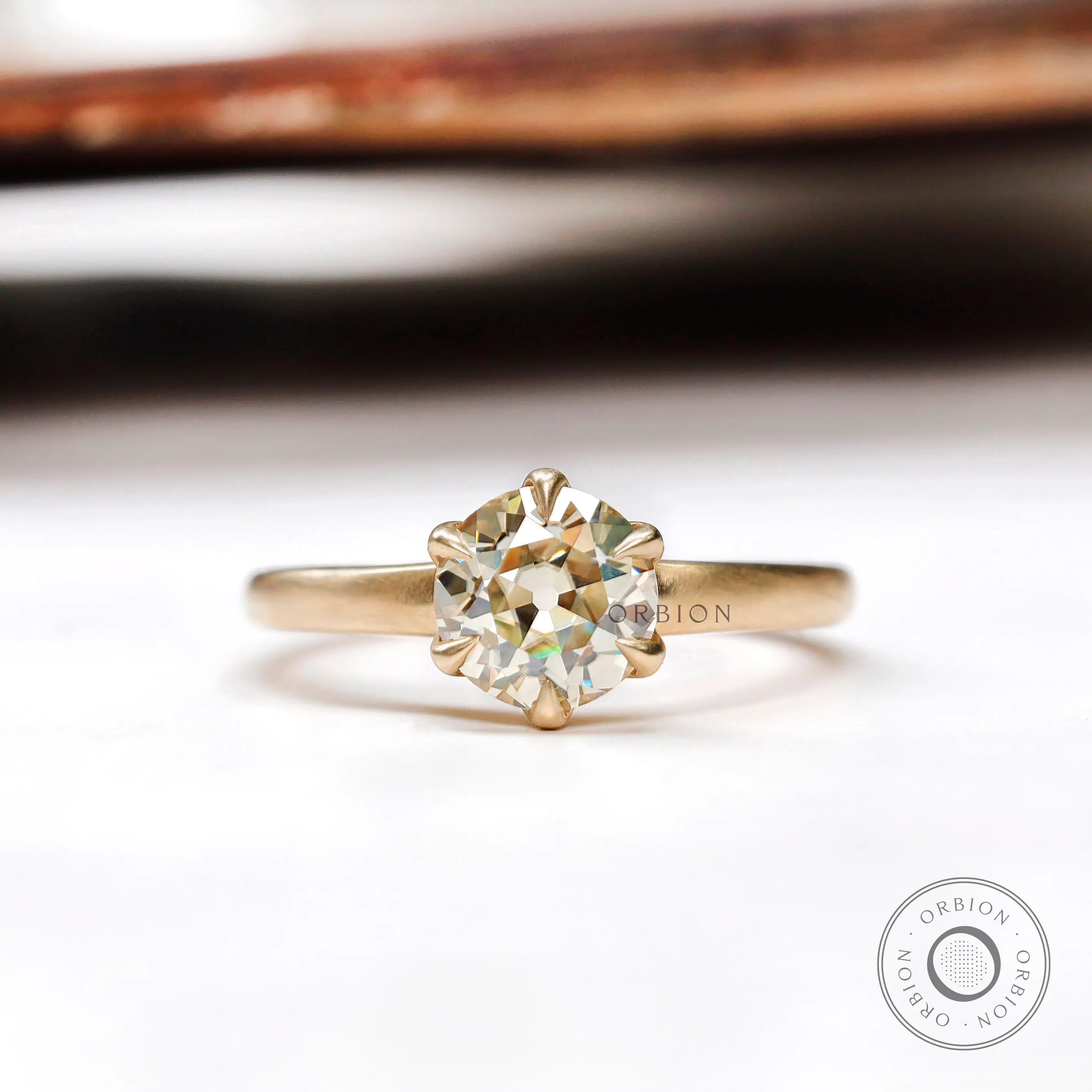Round old European cut light champagne moissanite solitaire ring in yellow gold