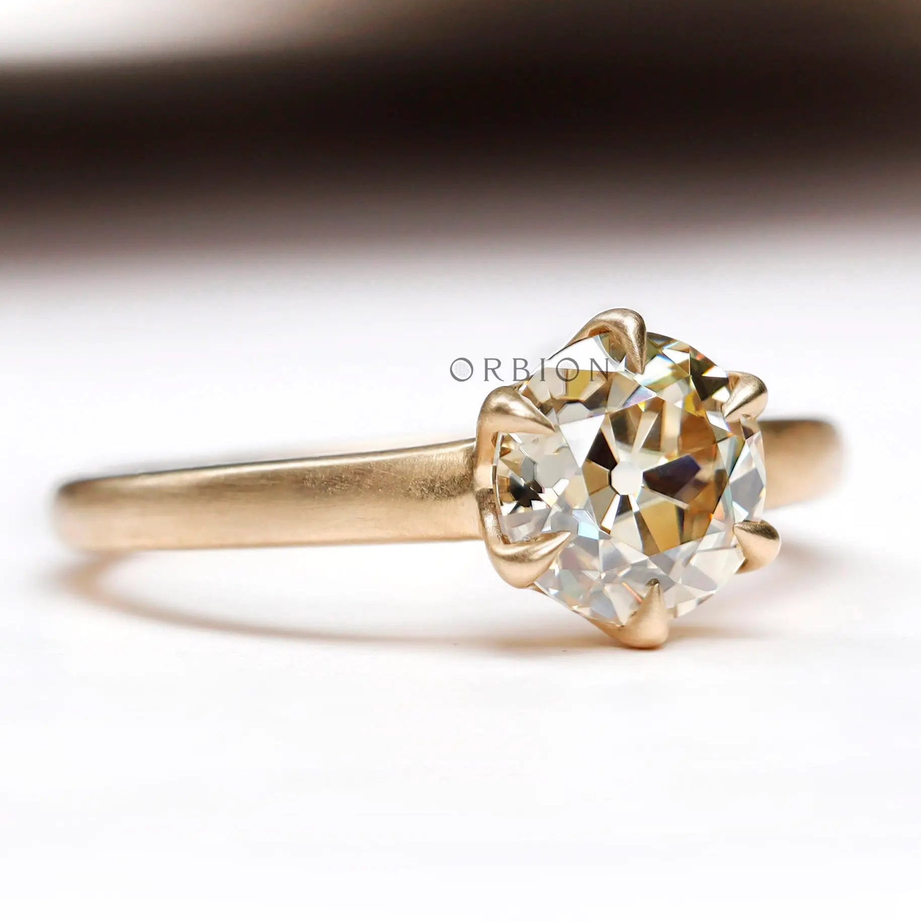 Front view of champagne moissanite solitaire ring in 10K yellow gold