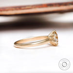 Side profile of round moissanite solitaire engagement ring