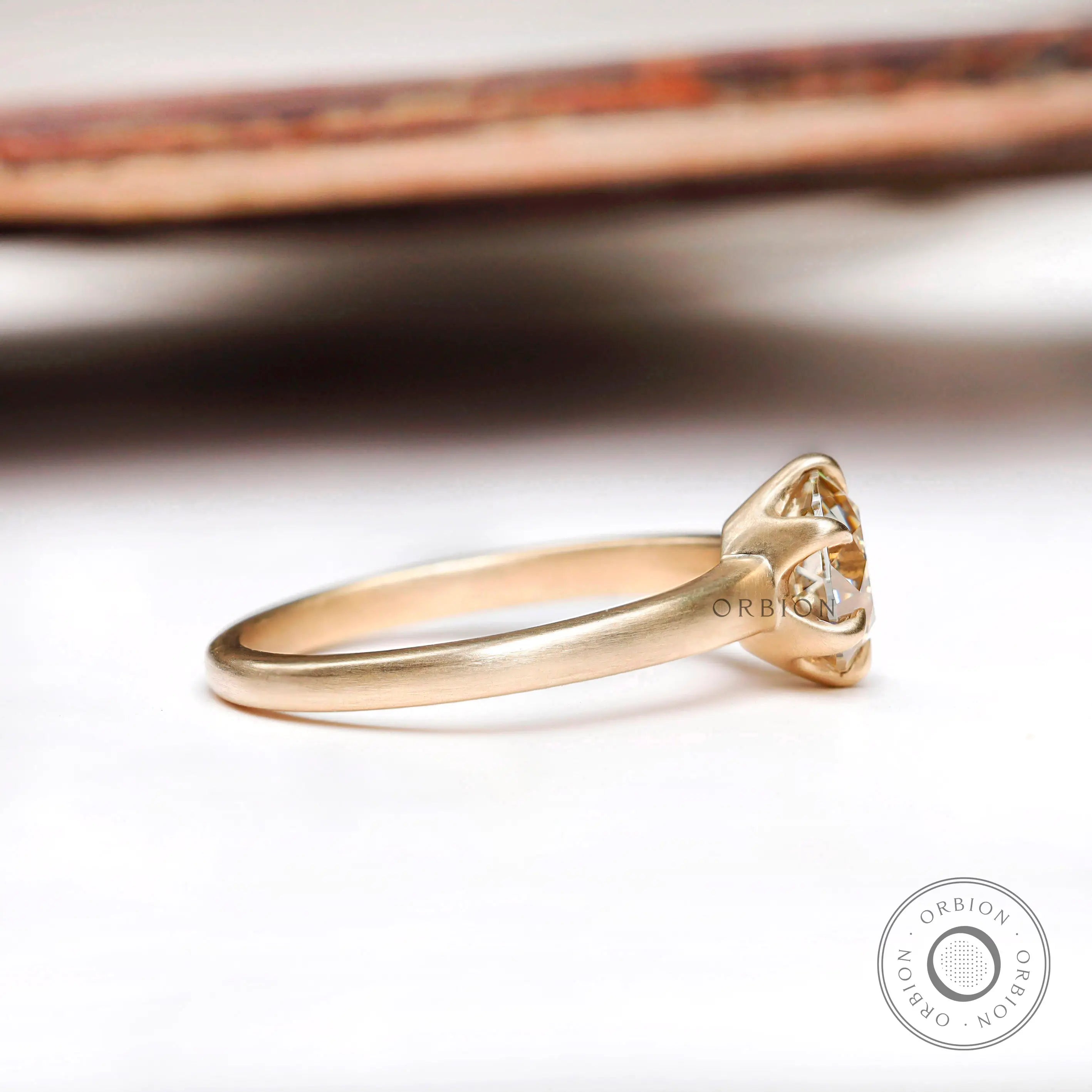 Side profile of round moissanite solitaire engagement ring