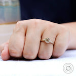Yellow gold moissanite solitaire ring worn on hand
