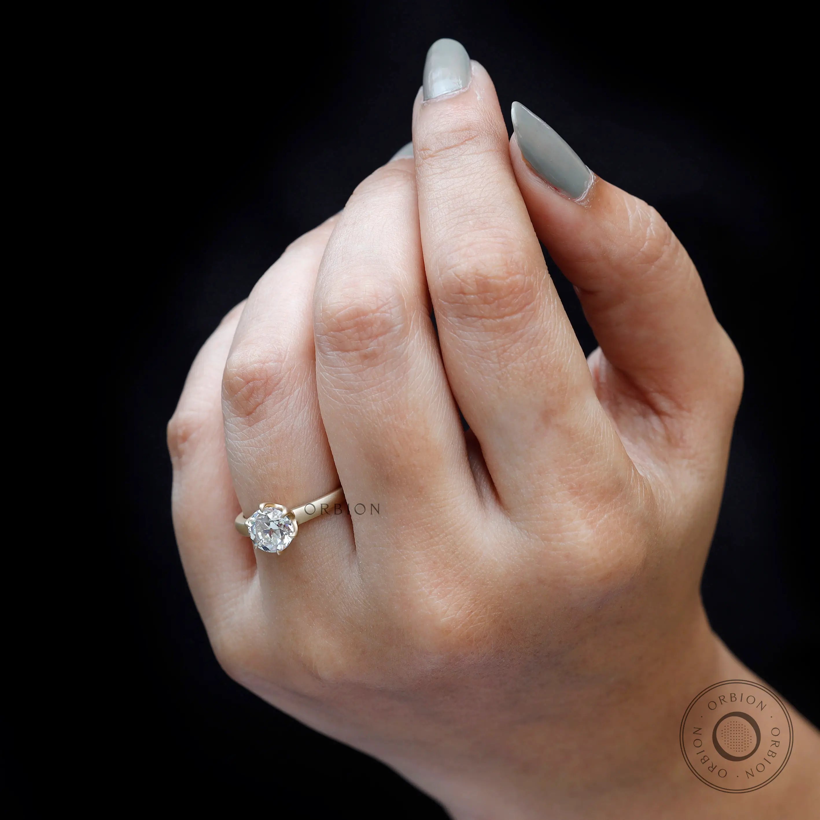 vintage solitaire engagement ring in yellow gold on finger