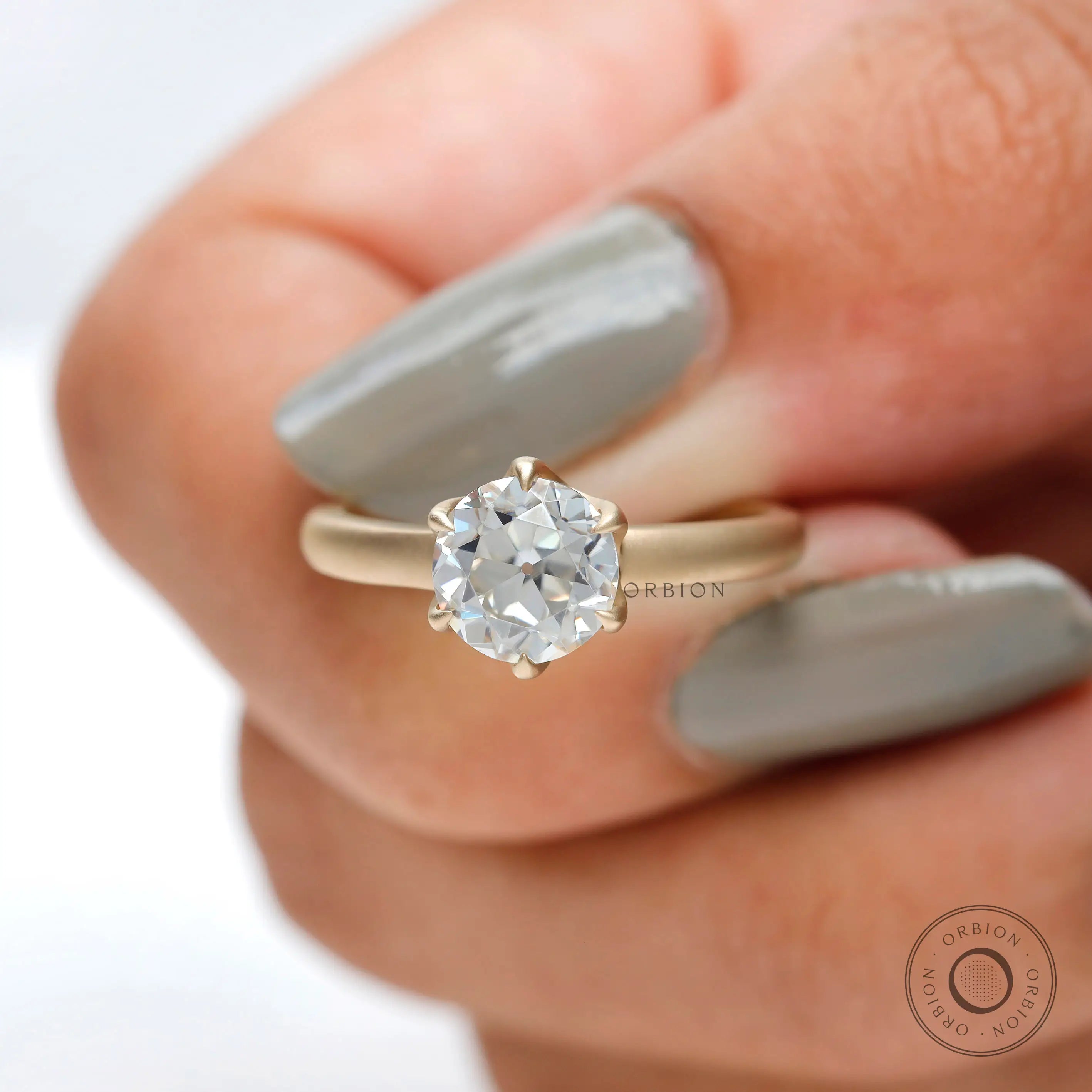 Elegant old european cut solitaire ring with matte gold band