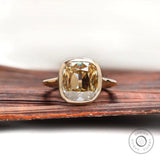 Front view of elongated cushion champagne moissanite bezel engagement ring