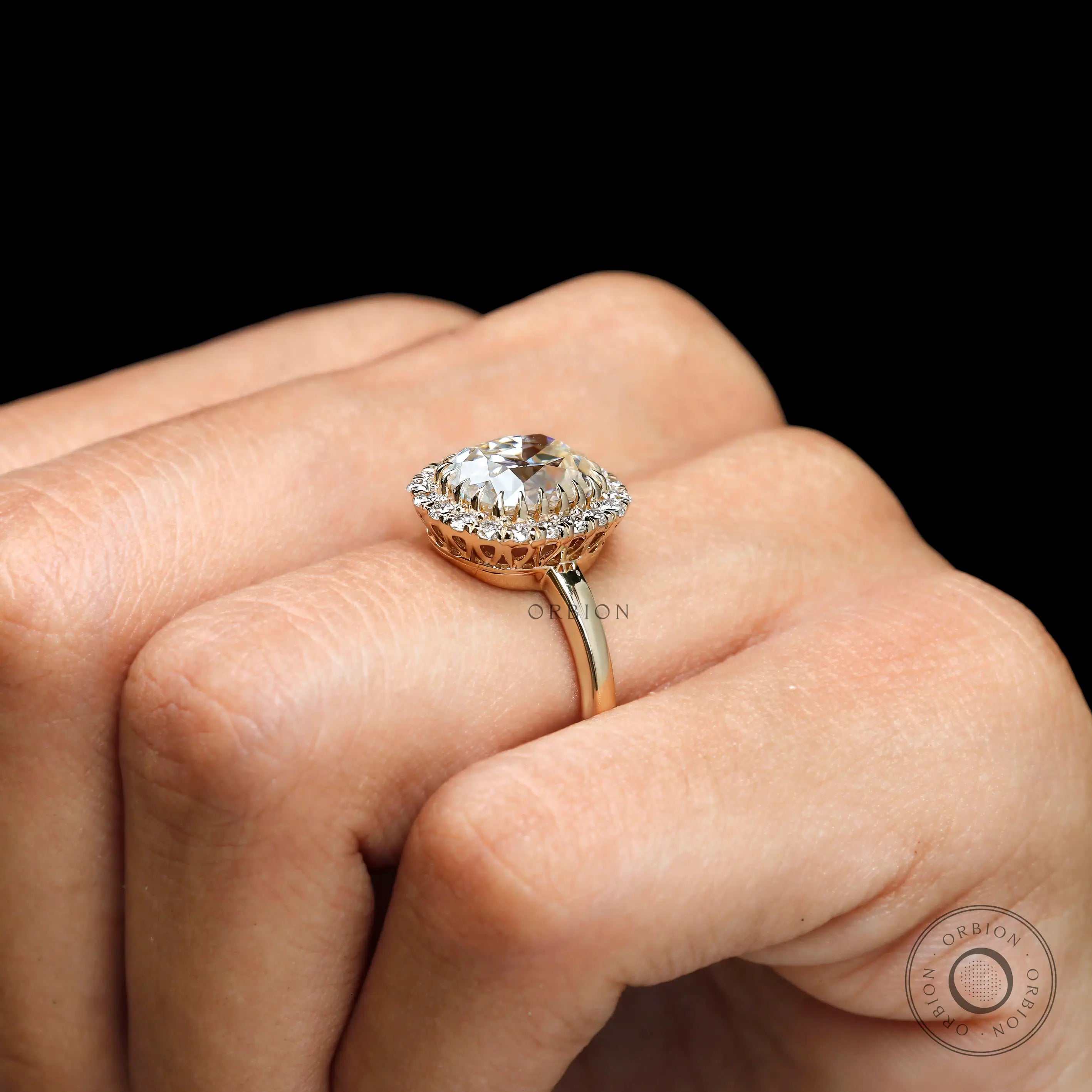 Vintage inspired cushion halo ring with diamond accents on fingure