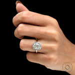 Antique style halo engagement ring on fingure