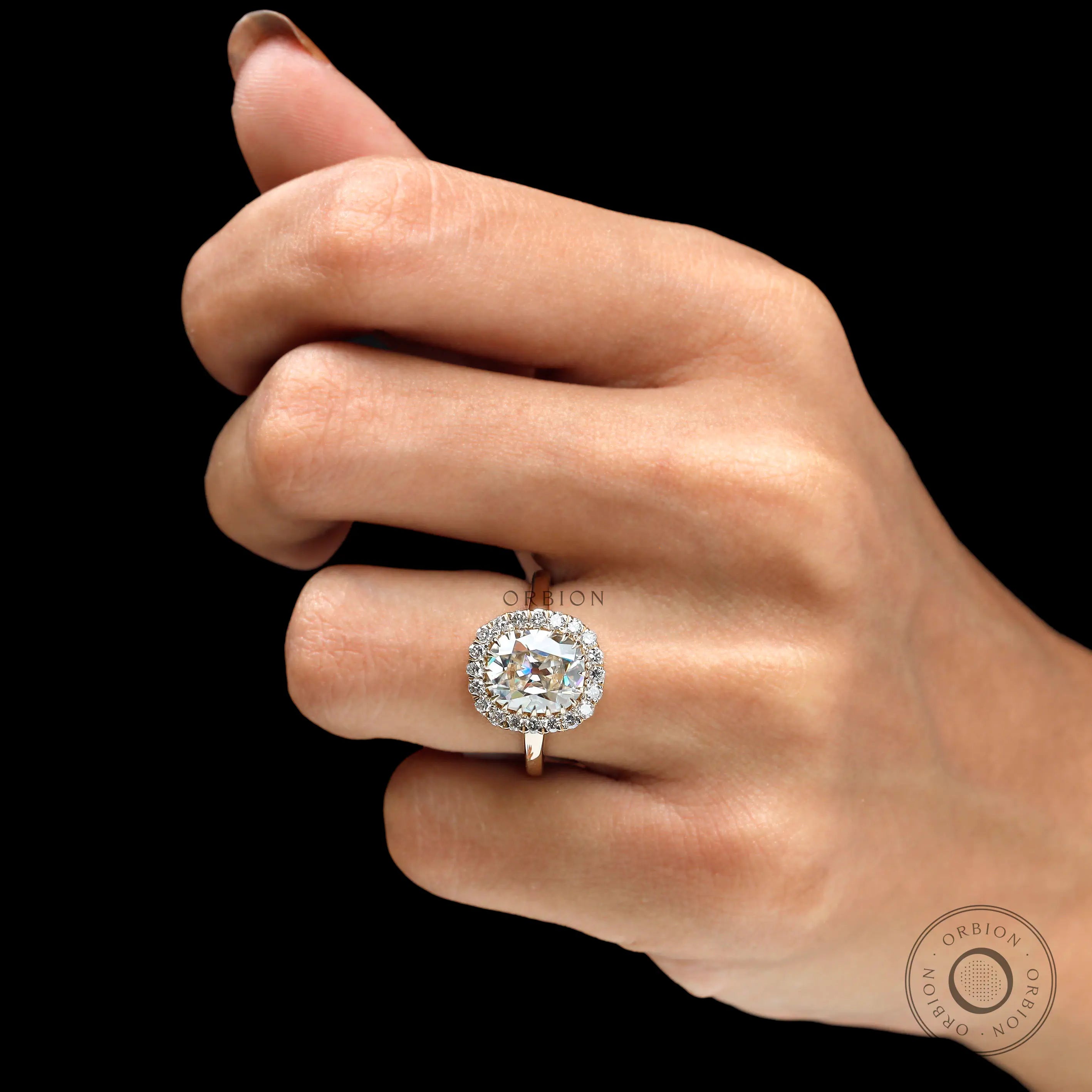 Antique style halo engagement ring on fingure