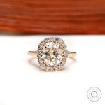 Elongated cushion old mine cut halo engagement ring in yellow gold