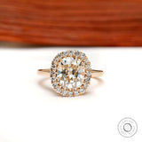 Elongated cushion old mine cut halo engagement ring in yellow gold
