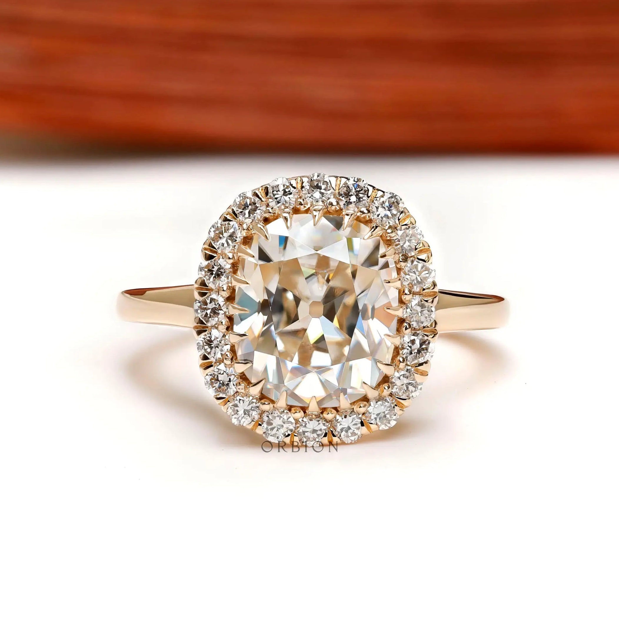Elongated cushion old mine cut halo engagement ring in yellow gold