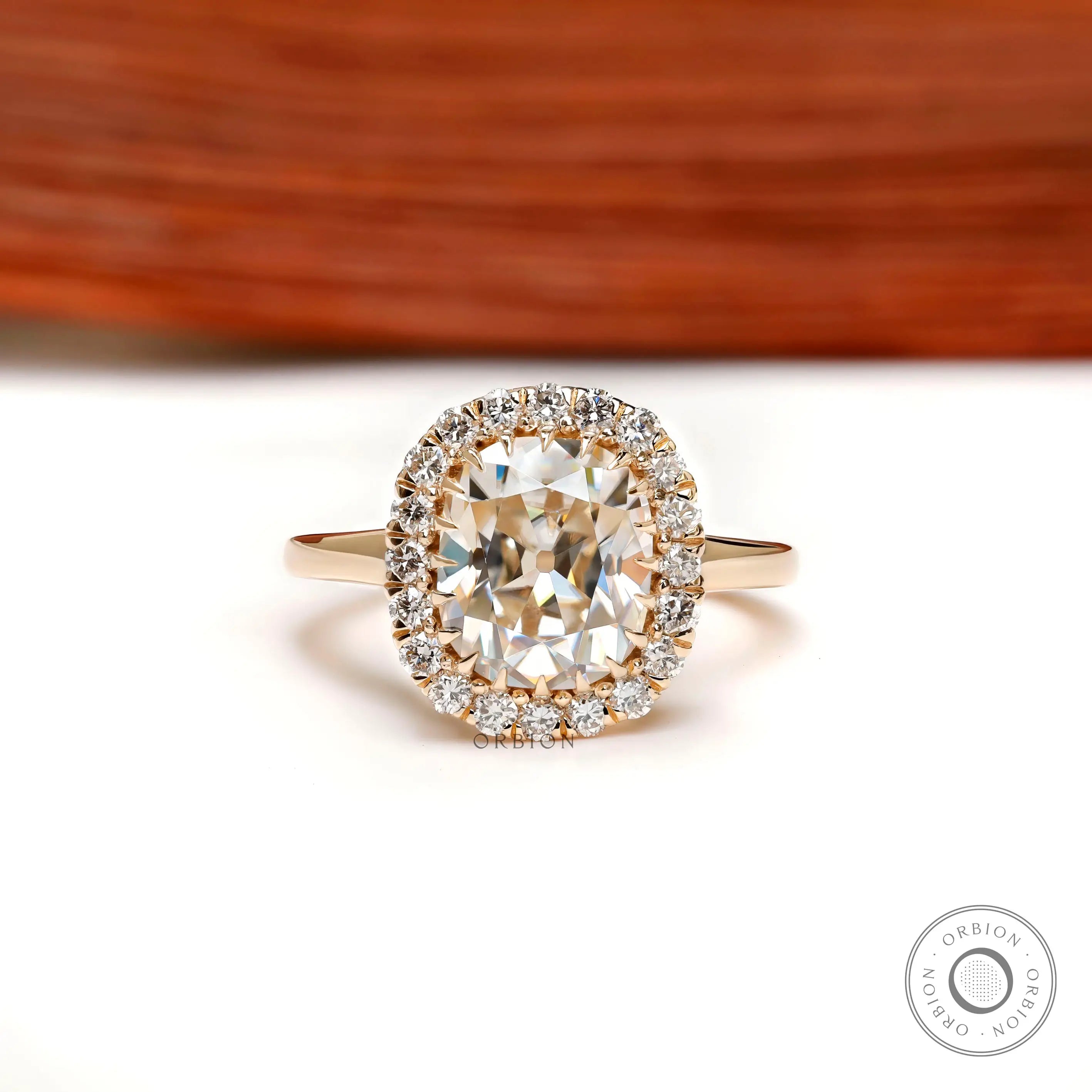Elongated cushion old mine cut halo engagement ring in yellow gold