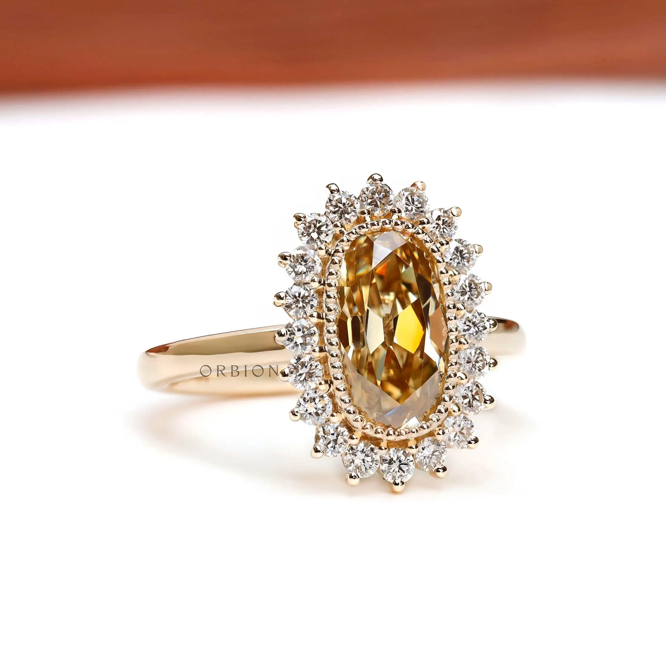 Elongated cushion Old Mine Cut champagne moissanite ring with milgrain halo