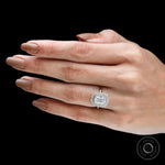Elongated cushion halo moissanite engagement ring in yellow gold on fingure