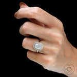 Yellow gold halo ring with round accent stones on fingure