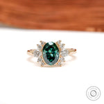 Front view of green oval moissanite floral cluster ring in yellow gold