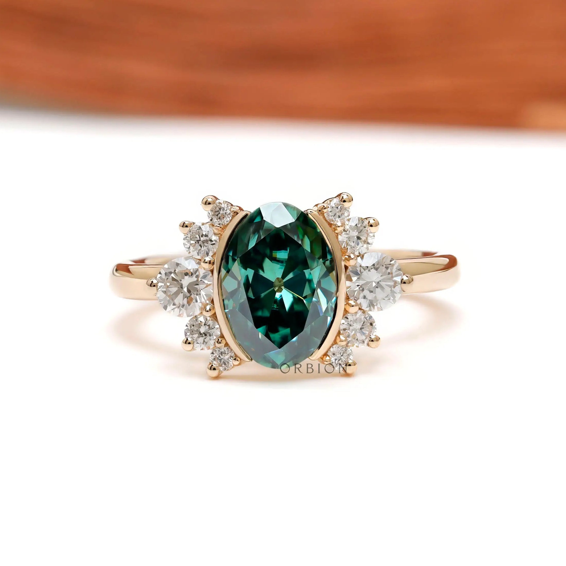 Front view of green oval moissanite floral cluster ring in yellow gold