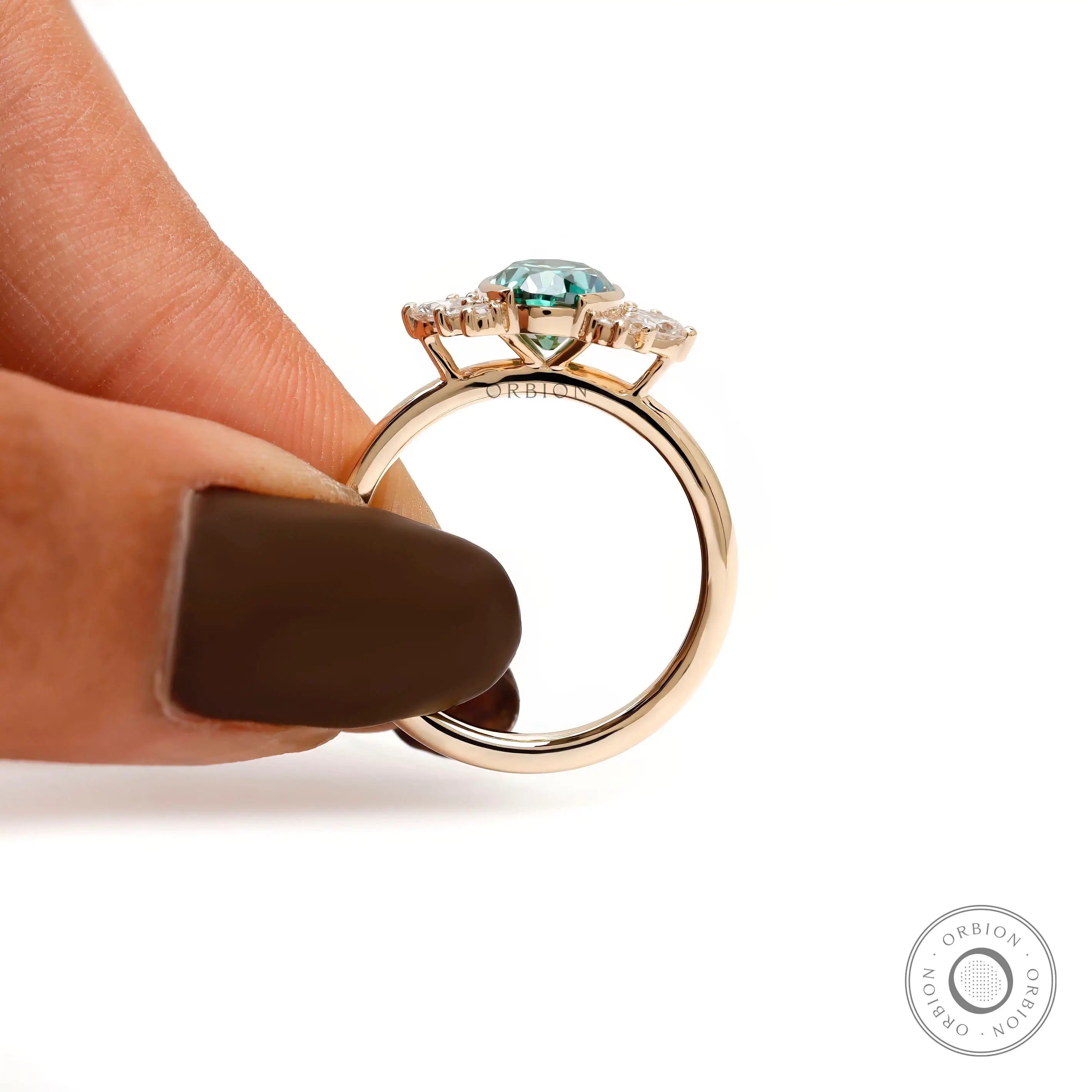 Angled side view highlighting oval green moissanite and prong details