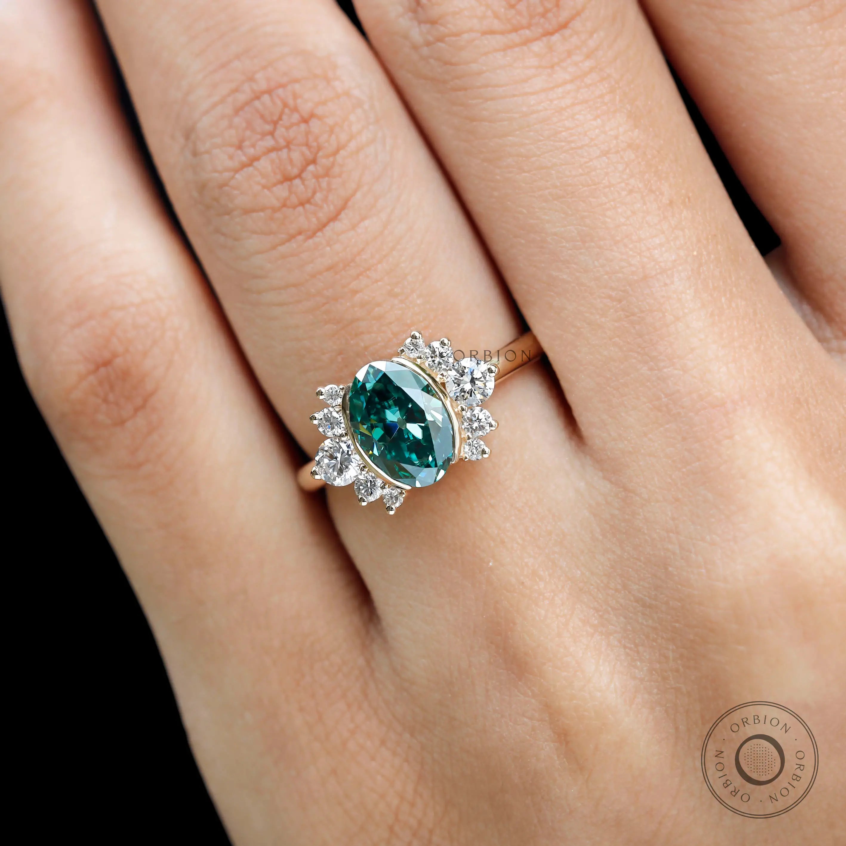 Close-up top view of green moissanite surrounded by floral diamond cluster
