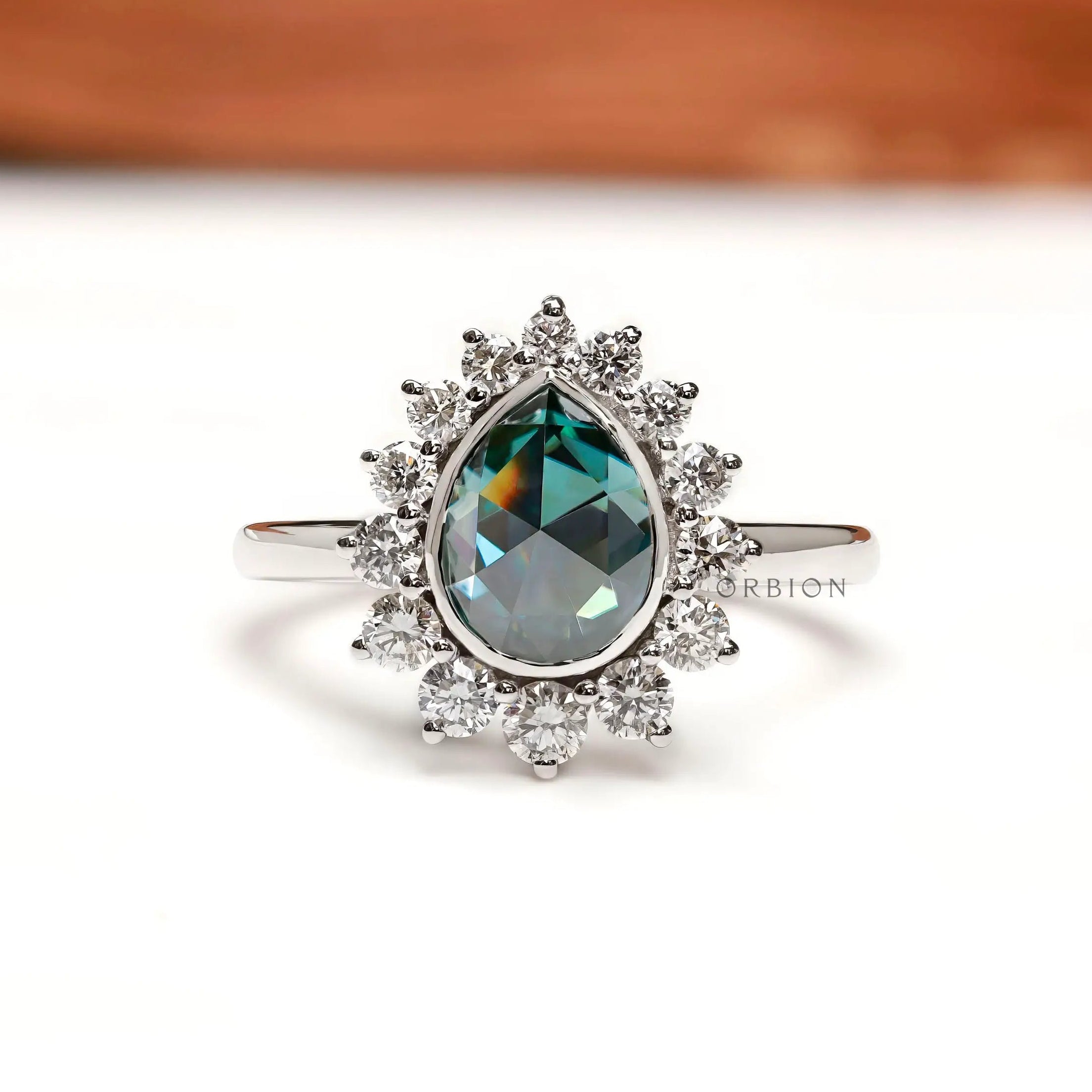 Pear rose cut blue green moissanite halo ring front view