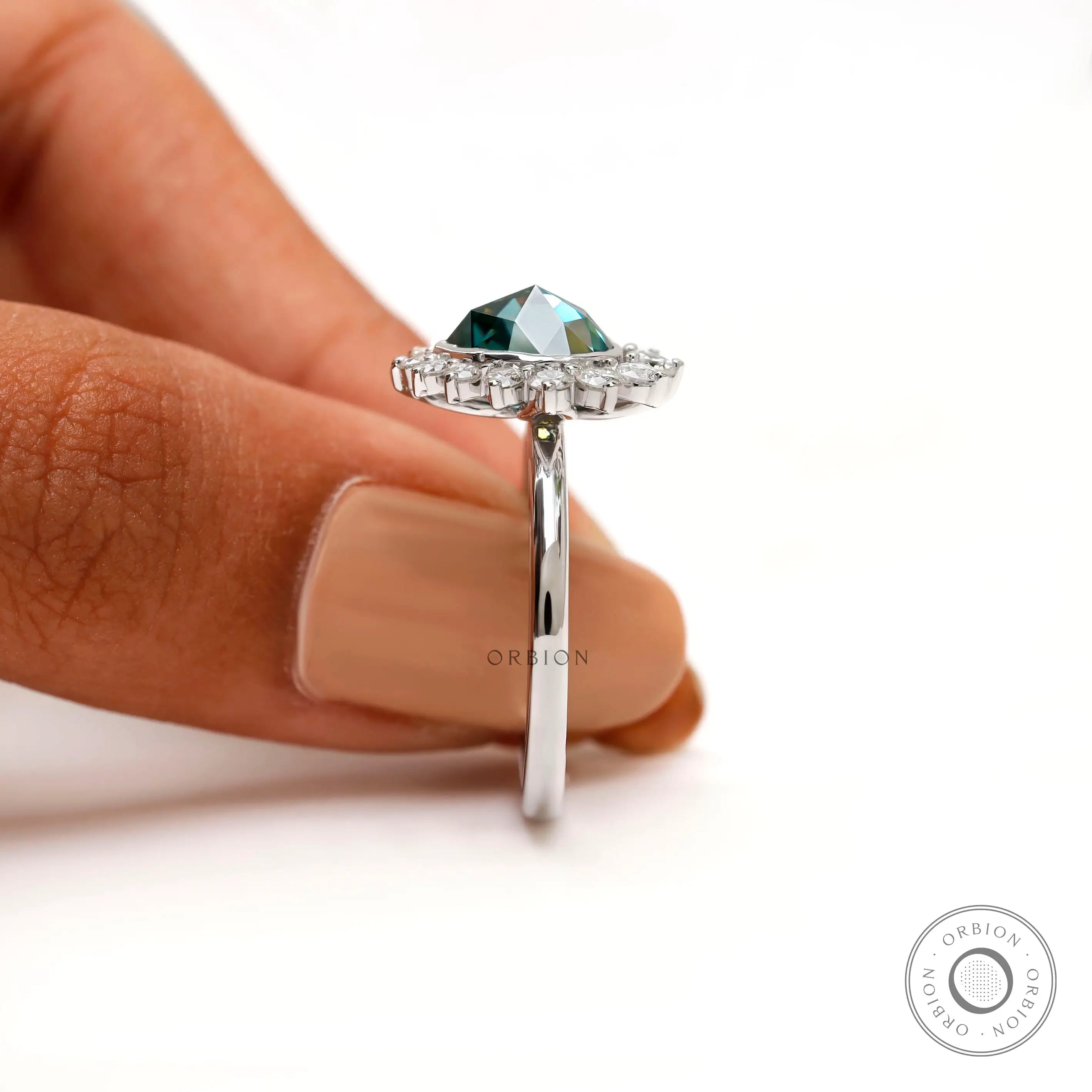 Angled side view pear rose cut moissanite halo ring