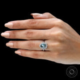 Pear moissanite halo ring on hand top view